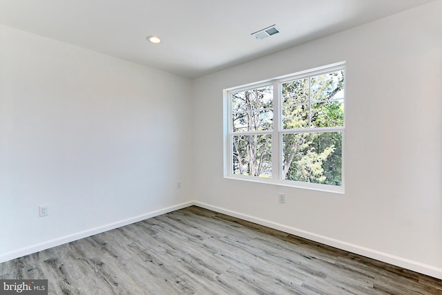 unfurnished room with light hardwood / wood-style flooring