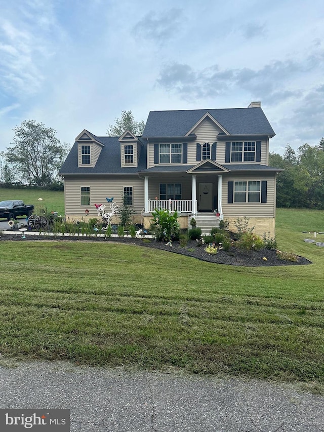 view of front of home featuring covered porch and a front yard