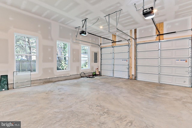 garage featuring electric panel and a garage door opener