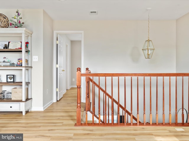 hallway with light hardwood / wood-style floors