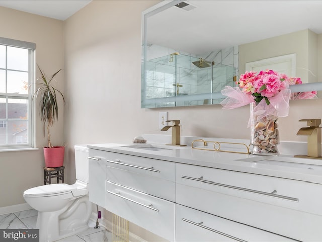 bathroom with a shower with shower door, vanity, and toilet