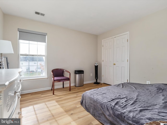 bedroom featuring a closet and light wood-type flooring