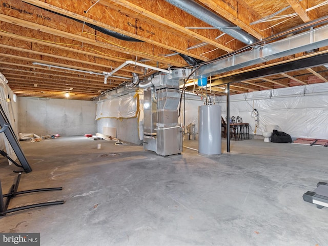 basement featuring gas water heater and heating unit