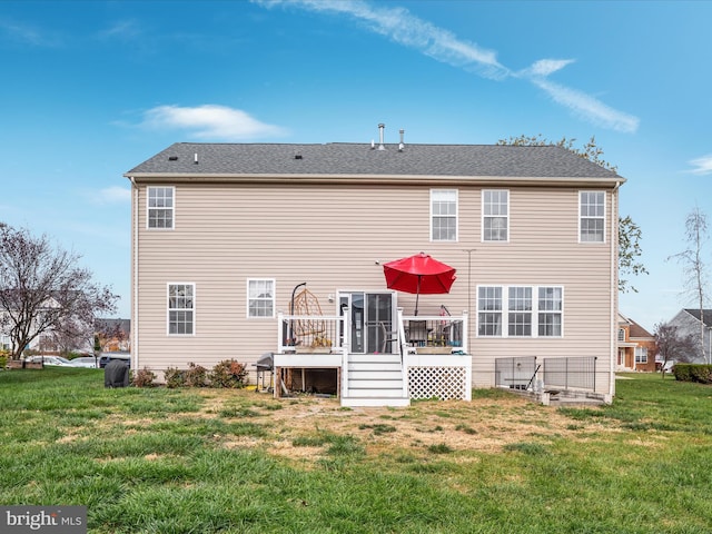 back of property featuring a deck and a yard