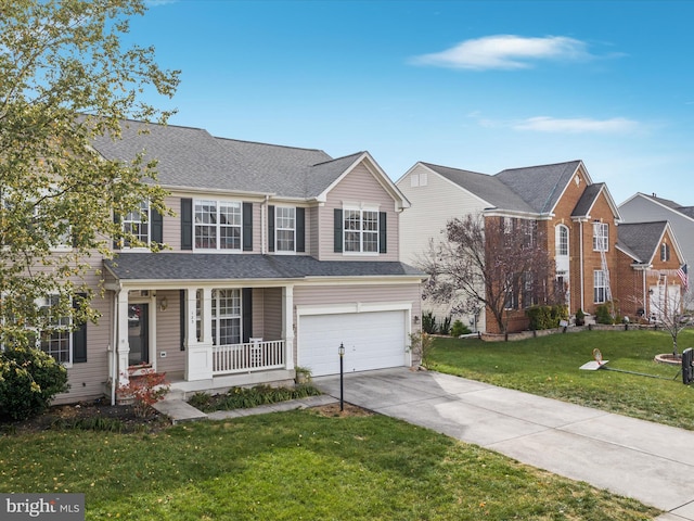 front facade featuring a front lawn, a garage, and covered porch