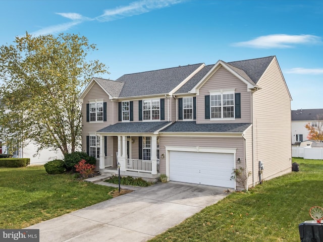 view of front of property with a front lawn, a garage, and covered porch