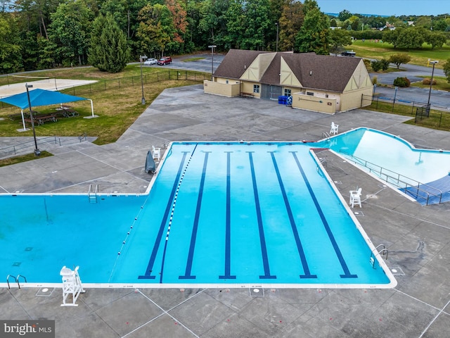 view of pool featuring a yard and a patio area