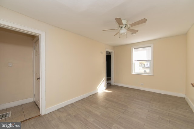 unfurnished room with light wood-type flooring and ceiling fan