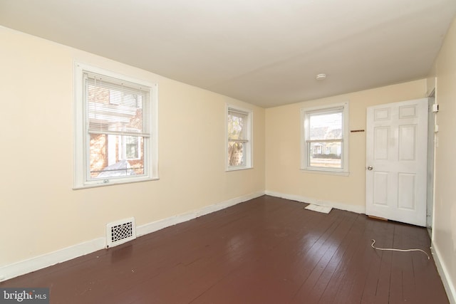 spare room featuring dark hardwood / wood-style floors