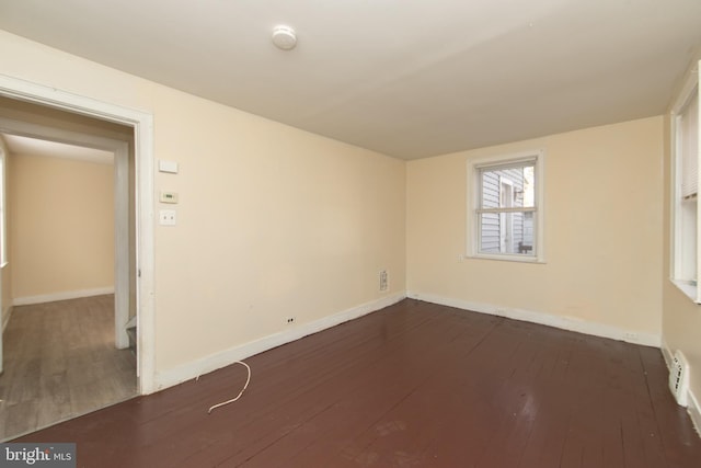 spare room featuring dark wood-type flooring