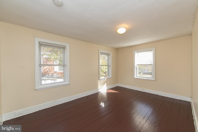 unfurnished room featuring dark wood-type flooring