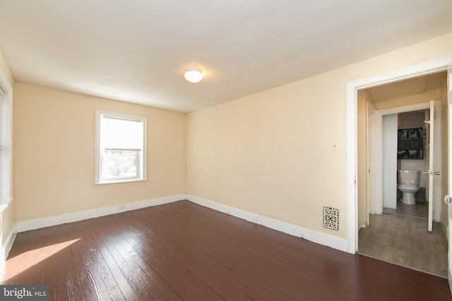 empty room featuring dark wood-type flooring