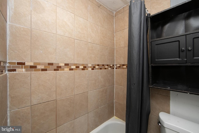 bathroom with shower / bath combination with curtain and toilet