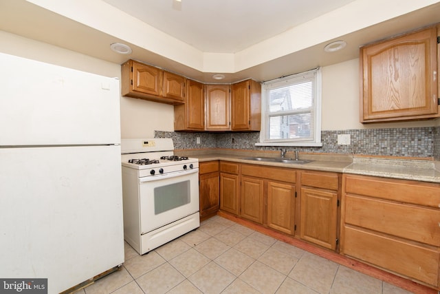 kitchen featuring sink, white appliances, backsplash, and light tile patterned floors