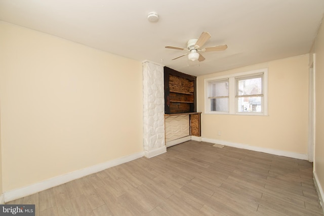 spare room featuring ceiling fan and hardwood / wood-style floors