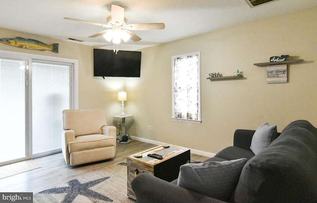 living room featuring light wood-type flooring and ceiling fan