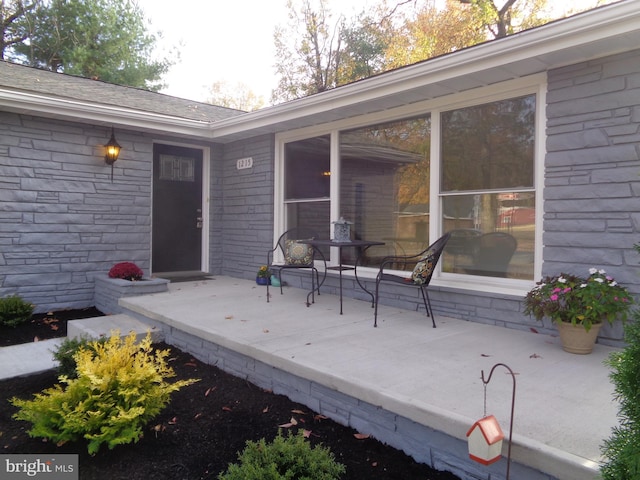 entrance to property featuring a patio