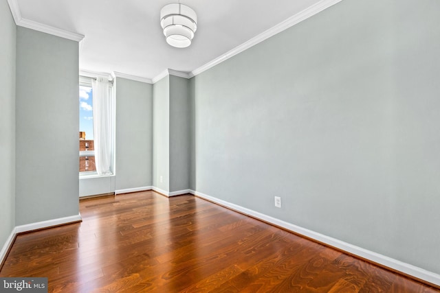 empty room featuring ornamental molding and wood-type flooring