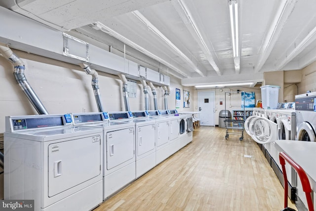 laundry room featuring light hardwood / wood-style flooring and washer and clothes dryer