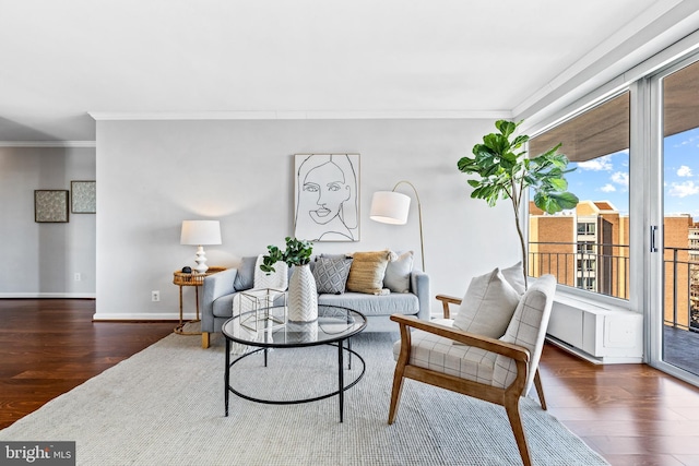 living room with ornamental molding, a healthy amount of sunlight, and dark hardwood / wood-style floors