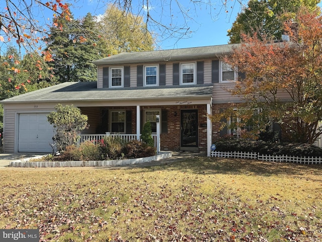 view of front property with a garage, a porch, and a front yard