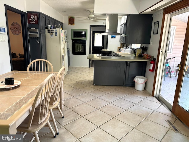 kitchen with island range hood, kitchen peninsula, oven, white refrigerator with ice dispenser, and ceiling fan