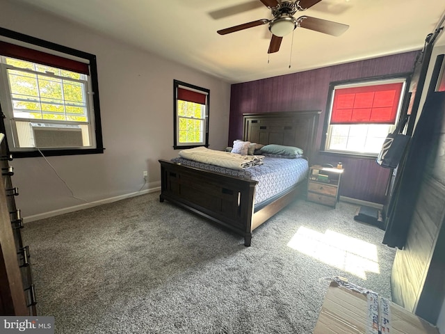 bedroom with ceiling fan, multiple windows, cooling unit, and carpet floors