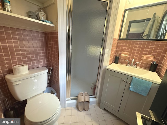 bathroom with walk in shower, tile patterned floors, and tile walls