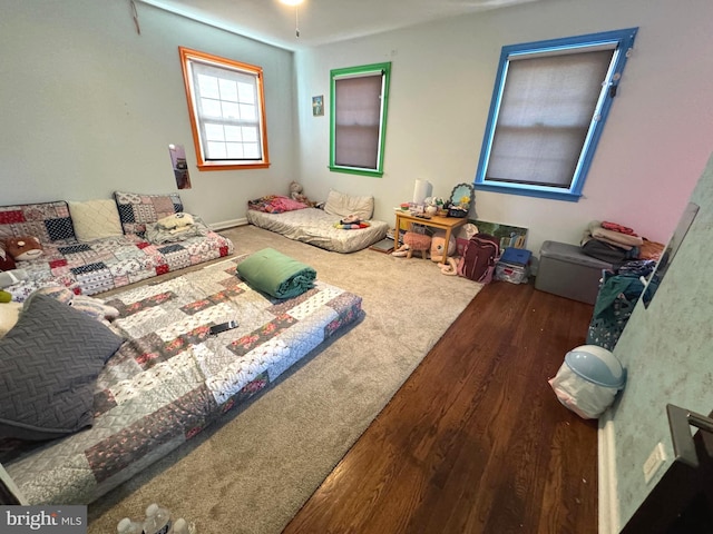 bedroom with dark hardwood / wood-style flooring