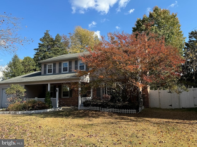 view of front of property with a porch and a front yard