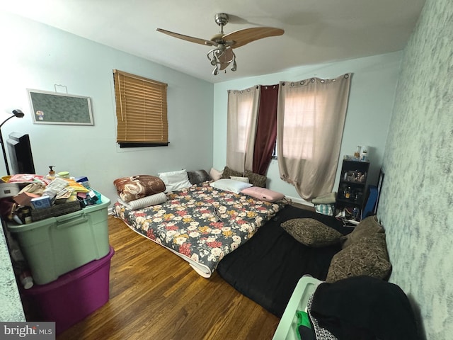 bedroom with ceiling fan and dark hardwood / wood-style floors