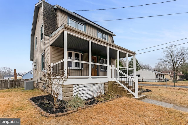 view of front facade with a porch and central AC