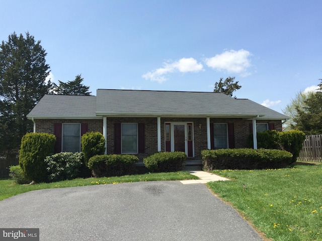 ranch-style house with a front lawn