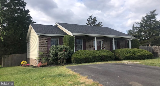 ranch-style home with a front lawn