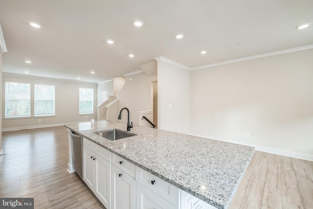 kitchen with crown molding, light wood-type flooring, light stone countertops, sink, and white cabinets