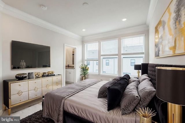 bedroom with multiple windows, crown molding, and ensuite bath