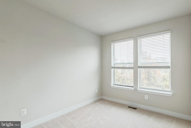 spare room with light colored carpet