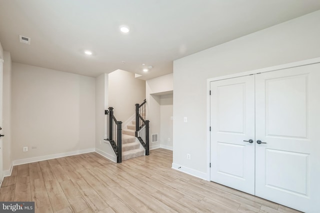 basement with light hardwood / wood-style floors