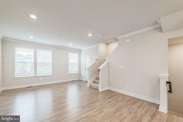 interior space with light hardwood / wood-style flooring and crown molding