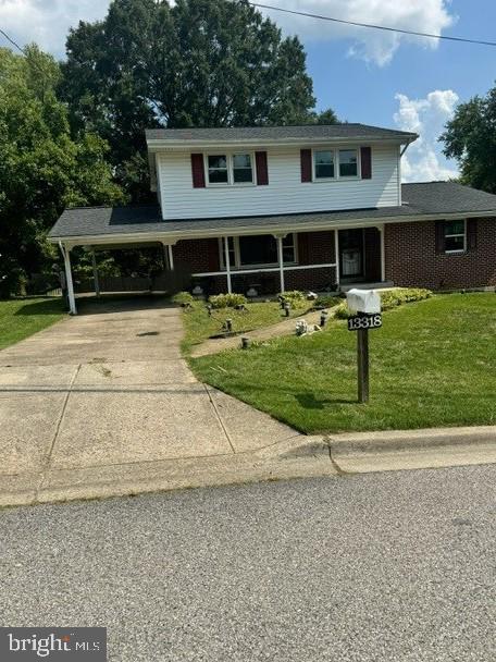 view of front facade with a front lawn and a carport