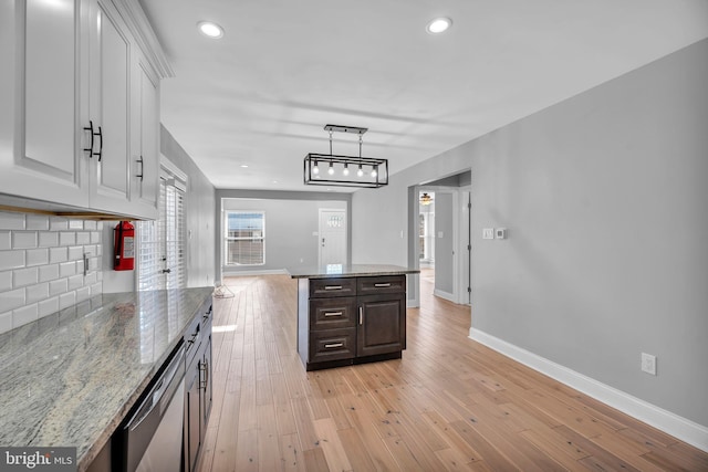 kitchen featuring baseboards, tasteful backsplash, white cabinets, light wood-style floors, and recessed lighting