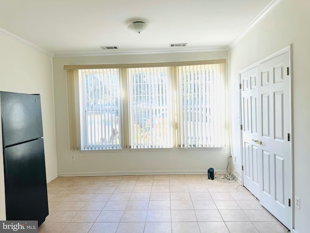 interior space featuring ornamental molding and light tile patterned floors