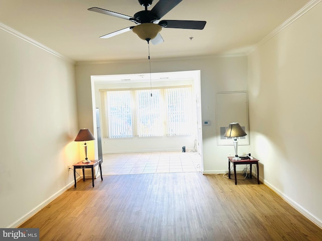 empty room featuring light hardwood / wood-style floors, ceiling fan, and crown molding