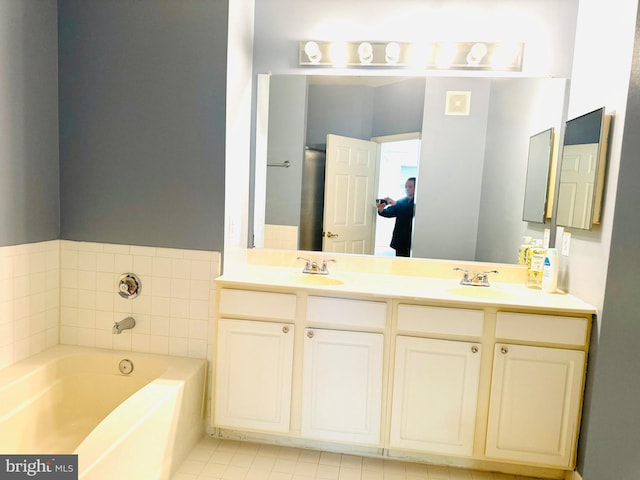 bathroom featuring vanity and a bath