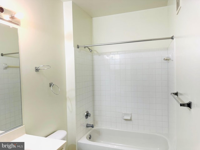 full bathroom with vanity, tiled shower / bath combo, and toilet