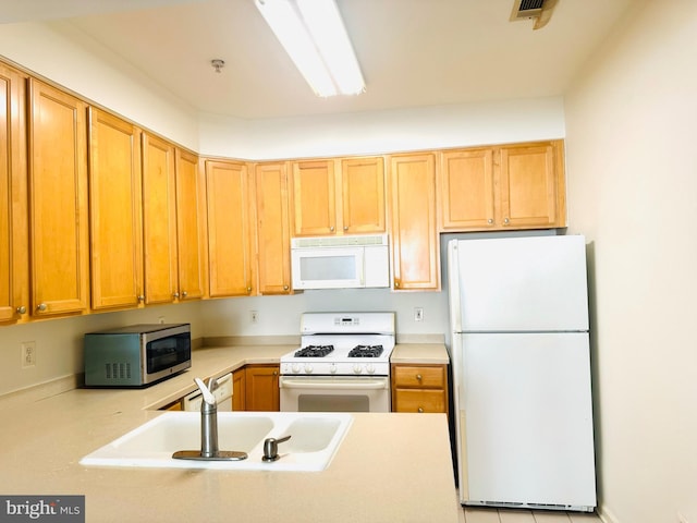 kitchen featuring white appliances and sink