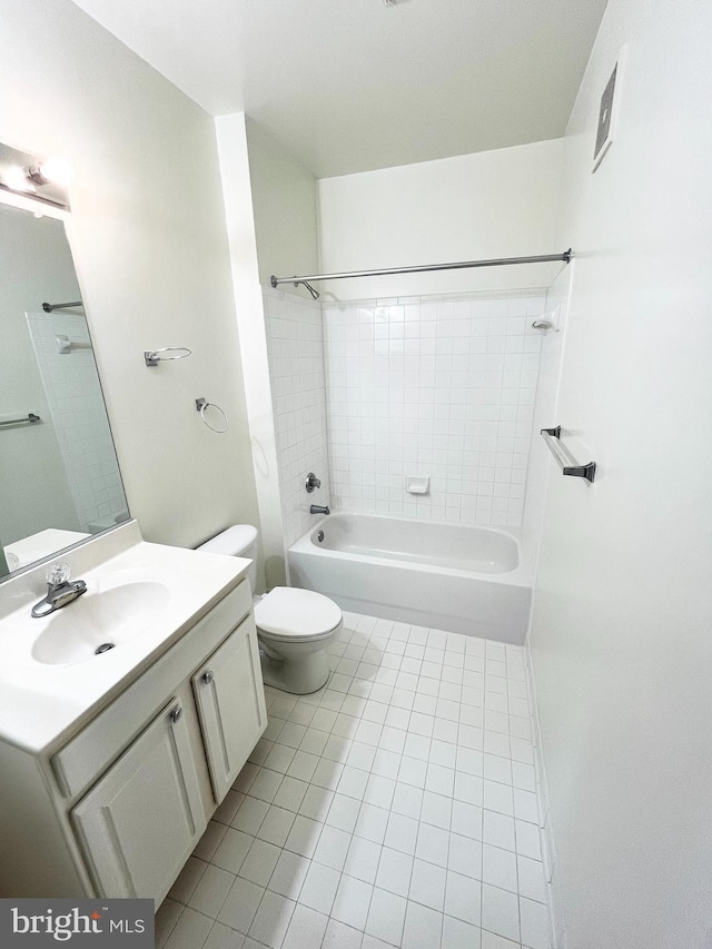 full bathroom featuring toilet, vanity, tile patterned floors, and tiled shower / bath combo