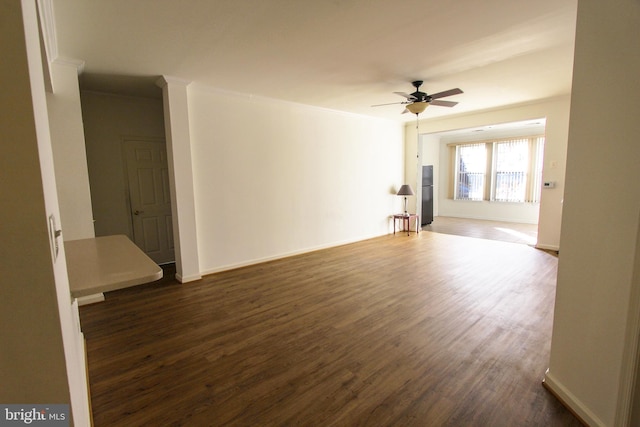 spare room with ceiling fan, crown molding, and dark hardwood / wood-style floors