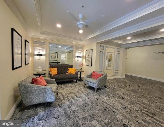 interior space featuring a raised ceiling, ceiling fan, and ornamental molding