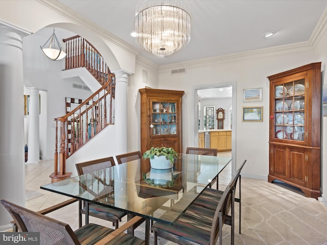 dining space with ornamental molding, light carpet, ornate columns, and an inviting chandelier